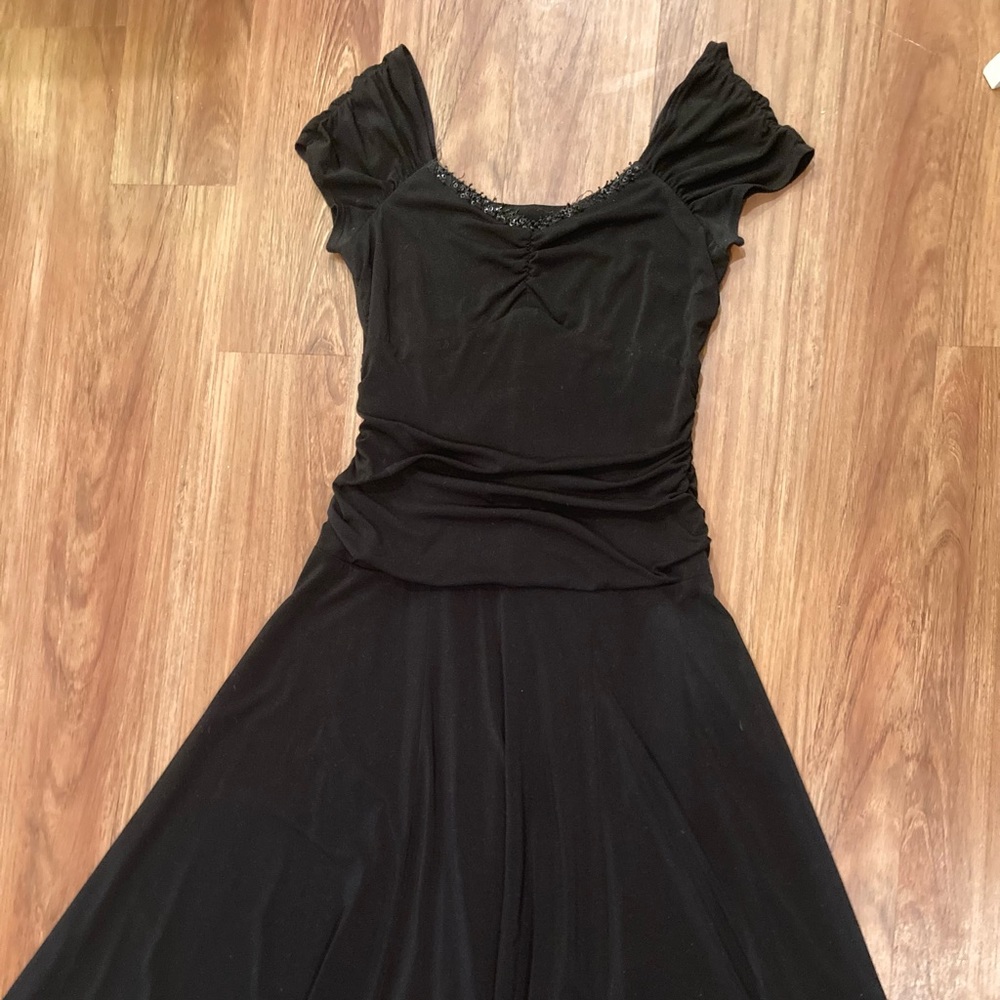 Shin-length black dress, stretchy (polyester and spandex), comfortable and flowy